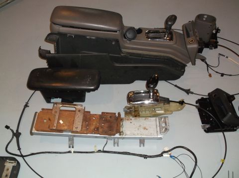 1999 Mercury Grand Marquis - Disassembled car center console and shifter assembly with wiring laid out on a floor.