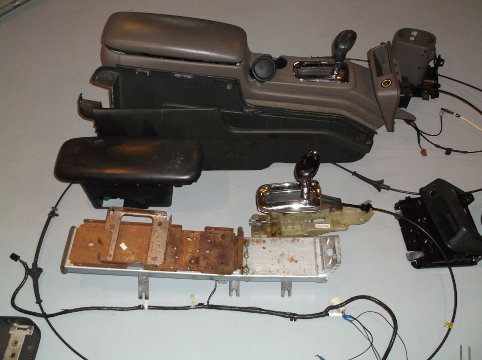 Disassembled car center console and shifter assembly with wiring
