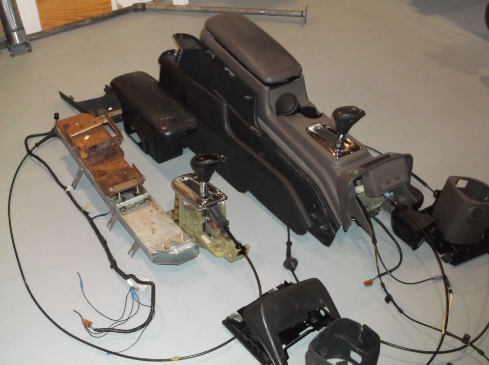 Disassembled car center console with shifter and wiring