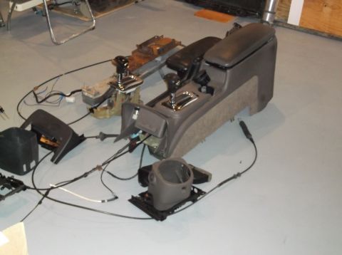 1999 Mercury Grand Marquis - Interior parts, including the center console and steering column, are laid out on a floor.