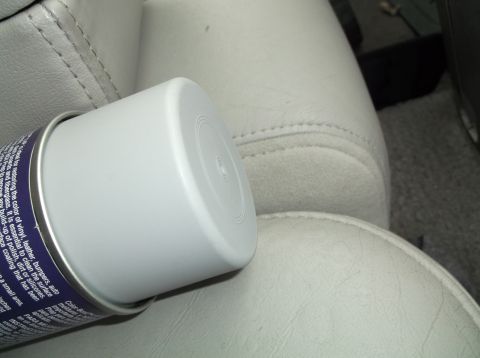 1999 Mercury Grand Marquis - A spray can rests on the interior car seat, obscuring any specific vehicle details.
