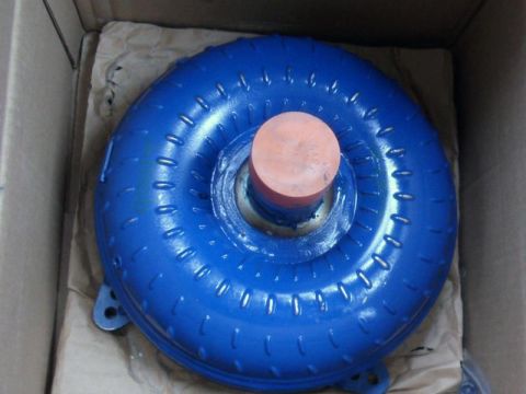 2001 Mercury Grand Marquis - This is a blue torque converter, likely a replacement part, shown inside its shipping box.