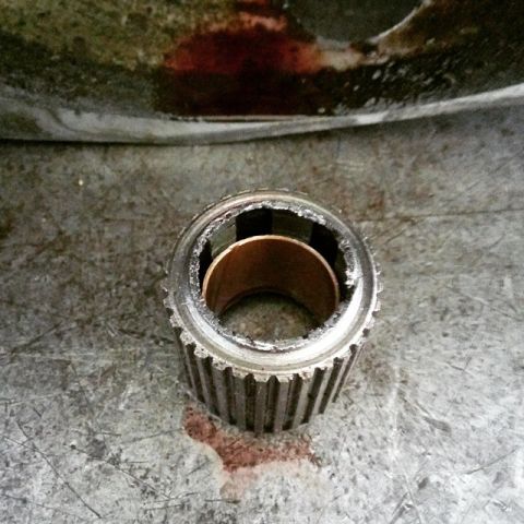 2001 Mercury Grand Marquis - A close-up view of a damaged transmission component, possibly a gear or clutch hub, showing significant wear and tear.