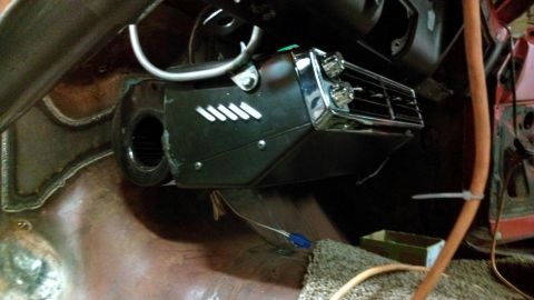 1964 Ford Fairlane - Close-up of an aftermarket heater unit installed in a vehicle's interior, showing its control knobs and air vents.