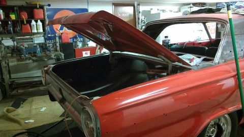 1964 Ford Fairlane - 1964 Ford Fairlane undergoing restoration in a garage, with its trunk and hood open.