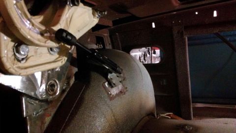 1964 Ford Fairlane - Close-up view of the floor pan and shifter mechanism inside a vehicle's interior.