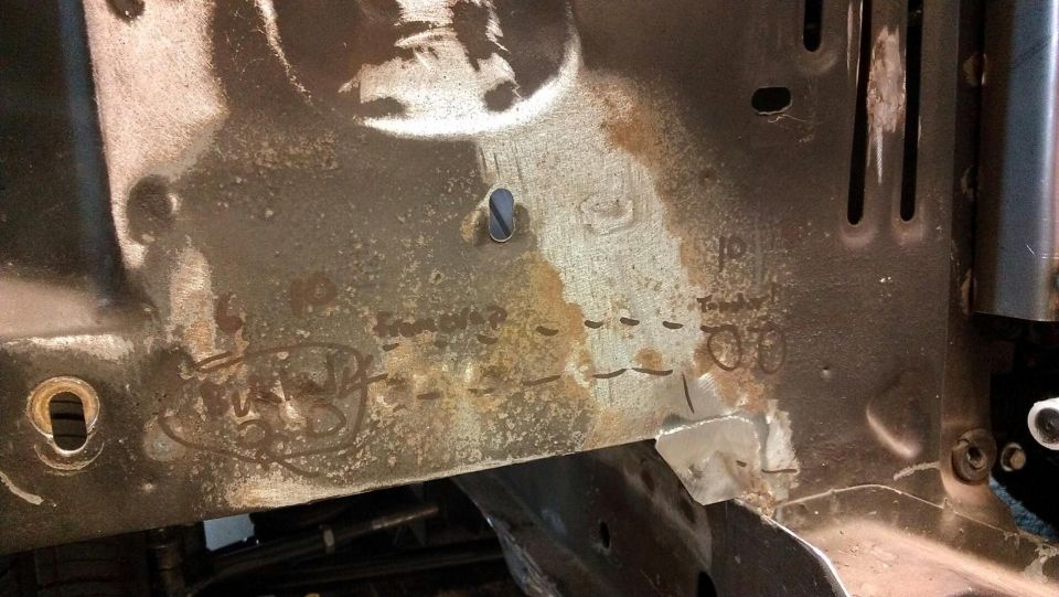 rusted metal frame with handwritten markings and stamped numbers