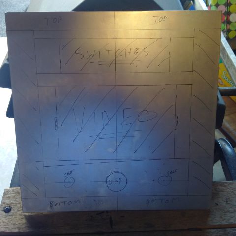 1978 Ford Bronco - Photo of a metal panel blank scribed with a hand-drawn fabrication layout for switches, a video monitor, seat heaters, and USB.