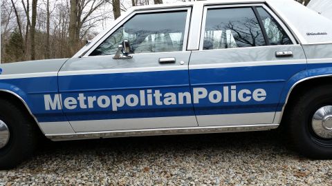 1991 Ford LTD Crown Victoria - Side view of a 1991 Ford Crown Victoria LTD police car with 'Metropolitan Police' text on the door.