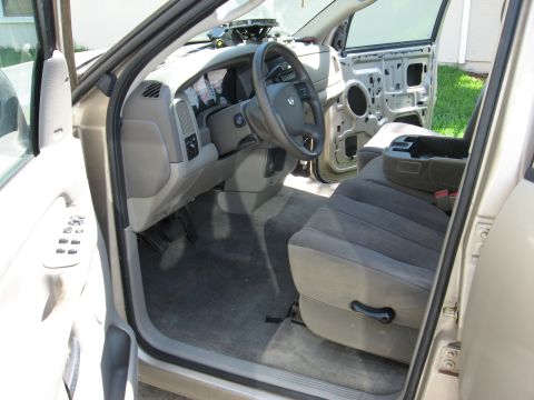 1994 Ford Bronco - The interior of a Dodge Ram pickup truck is shown with the driver's side door open and the door panel removed.