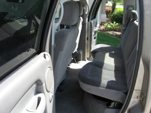 1994 Ford Bronco - Interior view of a truck's rear seating area, showing gray cloth upholstery and door panel details.