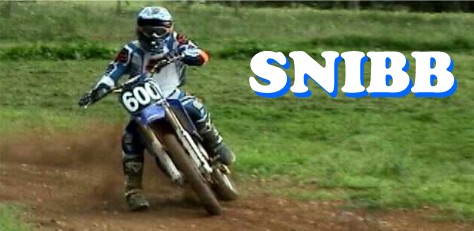 1995 Ford Bronco - A rider in full gear navigates a dirt track on a dirt bike, with the word SNIBB displayed prominently.