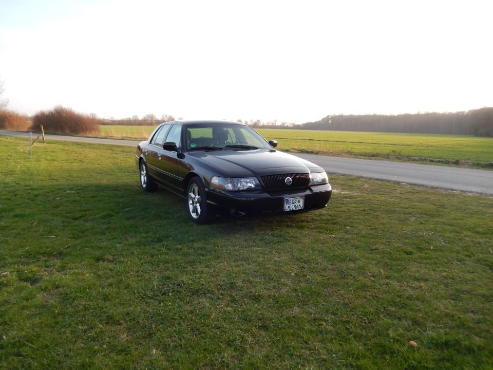 2003 Mercury Marauder parked on grass next to a field