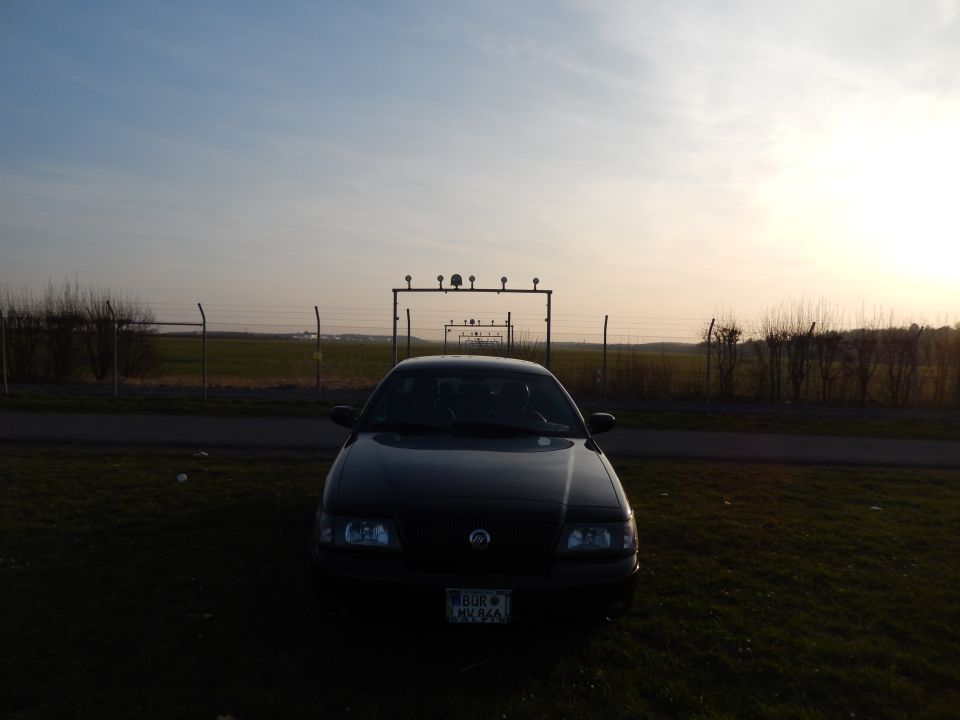 2003 Mercury Marauder parked in front of a fence and field at sunset