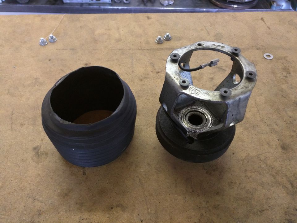 Automotive part with a rubber bellows and a metal hub assembly with wires