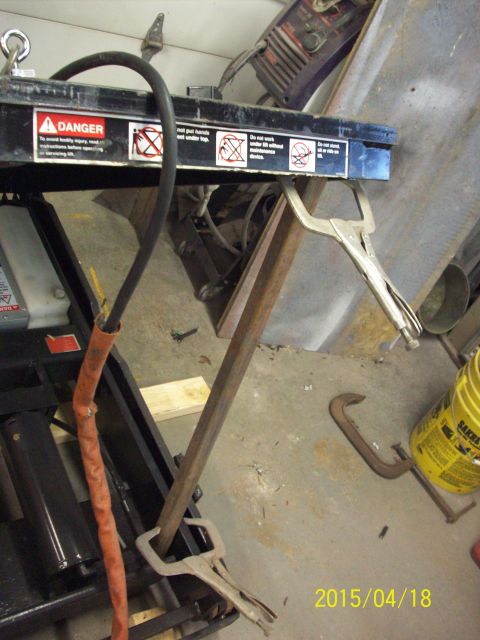 1969 Ford Torino - Shop equipment is secured with clamps, showing warning labels and a hose.