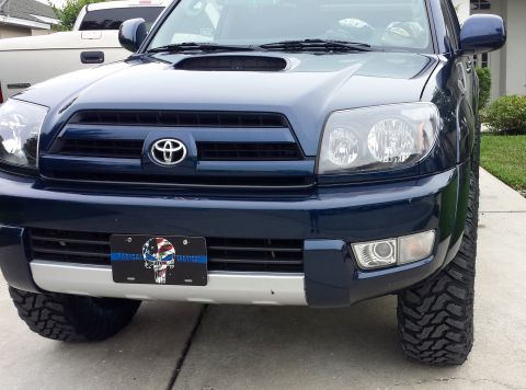 2005 Toyota 4Runner - Frontal view of a dark blue 2005 Toyota 4Runner, showing its grille and headlights.