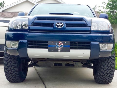 2005 Toyota 4Runner - Front view of a blue 2005 Toyota 4Runner with a lift kit and aggressive tires.