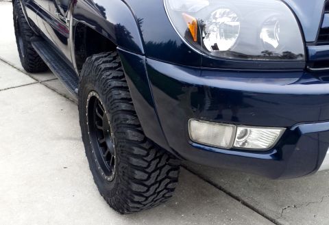 2005 Toyota 4Runner - This SUV features large, knobby tires and aftermarket black wheels, suggesting off-road capability.