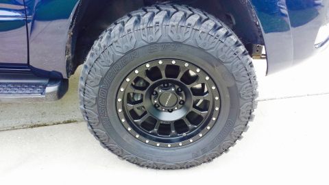 2005 Toyota 4Runner - Aftermarket wheel and tire upgrade on a blue SUV.