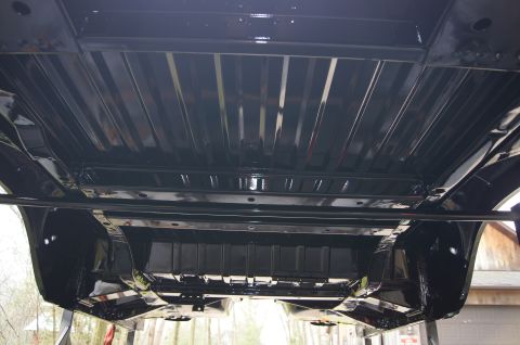 1979 Ford Bronco - The underside of a vehicle is shown, with a black finish on the frame and suspension parts.