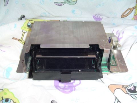 1999 Ford Taurus - Internal view of car stereo components, including circuit boards and a black housing.
