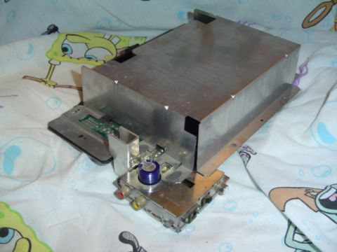 1999 Ford Taurus - An electronic component with various connectors and a blue capacitor is shown on a patterned cloth.