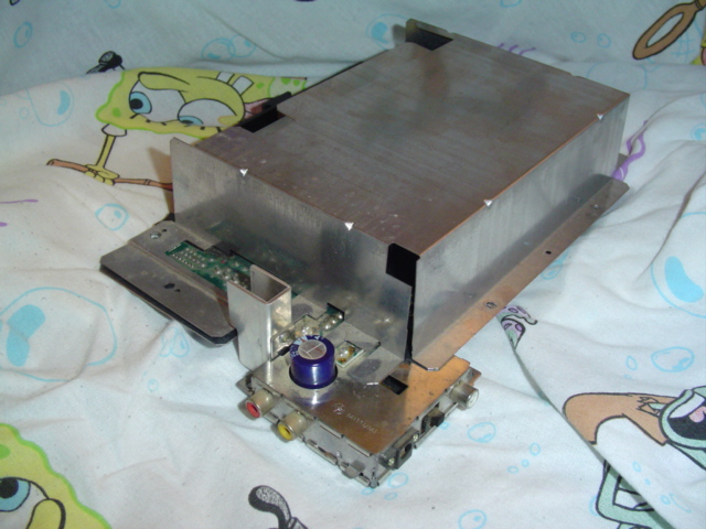 Metal electronic component with circuit boards and connectors, resting on a Spongebob Squarepants patterned cloth