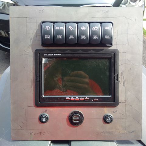 1978 Ford Bronco - A custom-made panel features auxiliary switches, a monitor, and USB ports, likely for off-road vehicle customization.