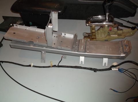 1999 Mercury Grand Marquis - Center console parts and wiring harness laid out on the floor.