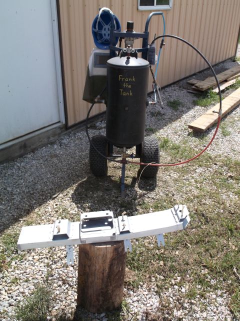 1999 Mercury Grand Marquis - Sandblaster tank and welding helmet, with a metal component displayed on a wooden stump.