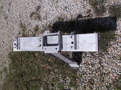1999 Mercury Grand Marquis - A metal frame component lies on a gravel and grass surface, with a website logo in the corner.