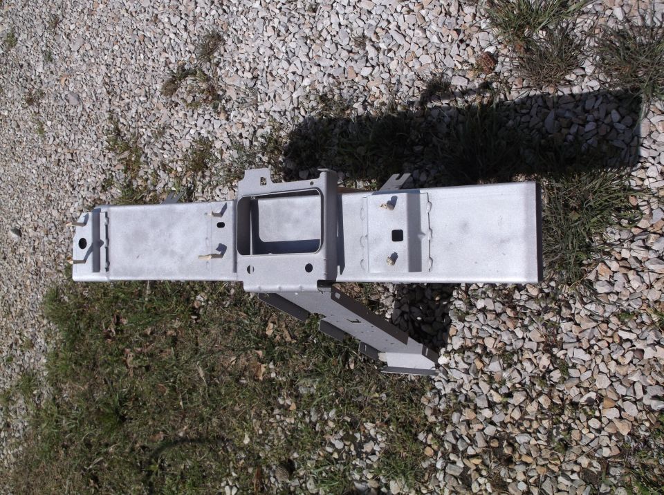 Metal frame part on gravel and grass. Supermotors.net logo visible