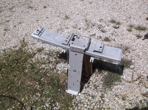 1999 Mercury Grand Marquis - A metal console part is displayed outdoors on a gravel surface.