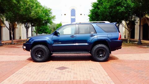 2005 Toyota 4Runner - This blue 2005 Toyota 4Runner is shown from the side, parked on a brick walkway.