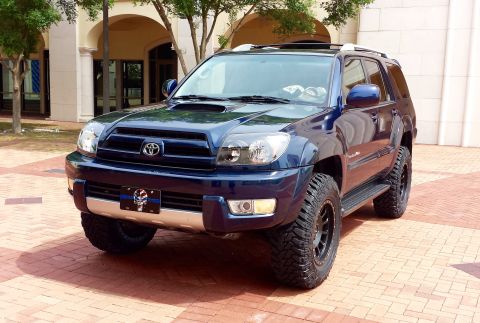 2005 Toyota 4Runner - This dark blue 2005 Toyota 4Runner is parked on a brick patio in front of a building with arched windows.
