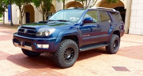 2005 Toyota 4Runner - A blue Toyota 4Runner SUV is shown from a three-quarter front angle, parked outdoors on a brick surface.