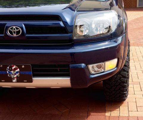 2005 Toyota 4Runner - Front view of a blue Toyota 4Runner, showing its grille, headlights, and a custom license plate.