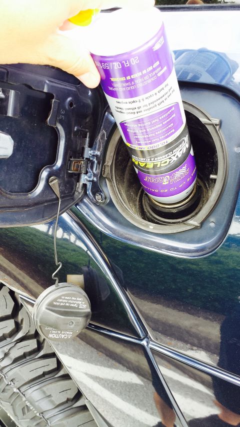 2005 Toyota 4Runner - Adding fuel system cleaner to the gas tank of a vehicle.