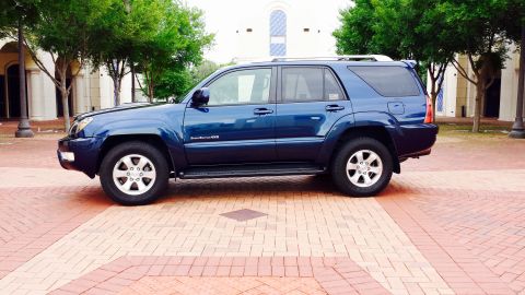 2005 Toyota 4Runner - A blue 2005 Toyota 4Runner is shown from the side, parked on a patterned brick surface.