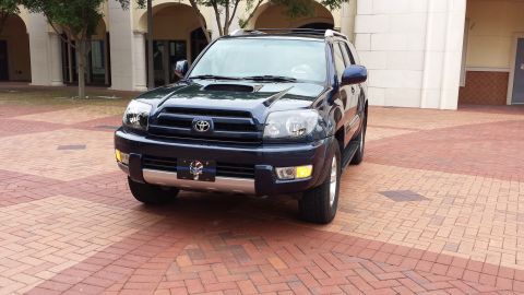 2005 Toyota 4Runner - Front 3/4 view of a dark blue 2005 Toyota 4Runner parked on a brick patio.