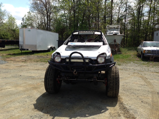Modified off-road vehicle with large tires and a bull bar