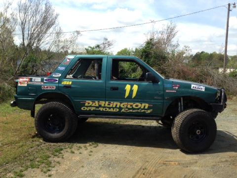 1999 Isuzu Vehicross - This modified off-road vehicle displays numerous racing decals and the number 11.
