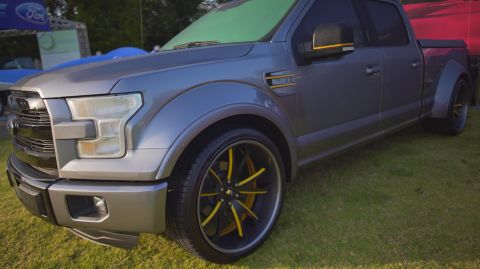 1995 Ford Taurus - This modified Ford F-150 pickup truck features custom wheels and yellow accents on its mirrors and fender vents.