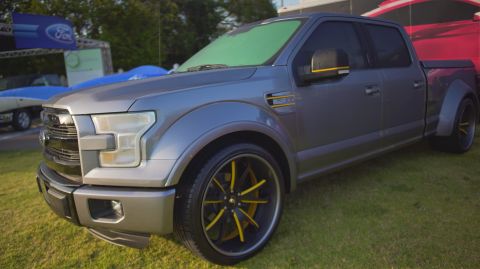 1995 Ford Taurus - Customized Ford F-150 pickup truck with aftermarket wheels and body modifications.