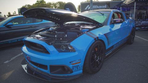 1995 Ford Taurus - A blue Ford Mustang is displayed with its hood up, revealing the engine compartment.