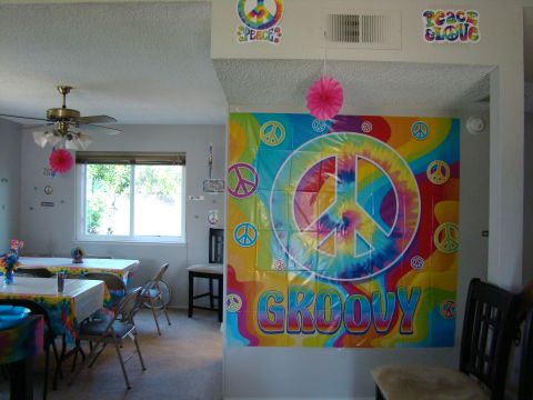 1989 Ford Bronco - Party decorations include peace signs and "GROOVY" banner.