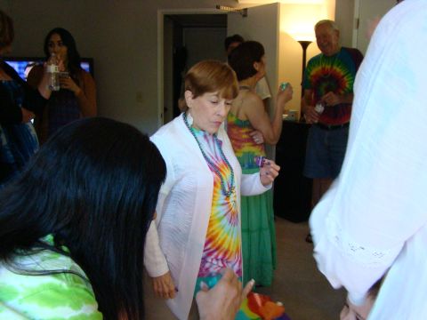 1989 Ford Bronco - A group of people in colorful tie-dye attire gather indoors.