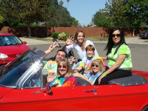 1989 Ford Bronco - A group of friends enjoys a sunny day ride in a classic red convertible.