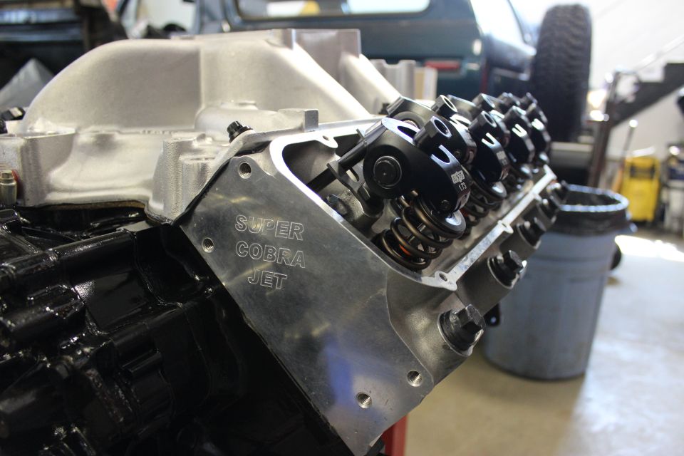 Close-up of a V8 engine block and valve cover labeled "Super Cobra Jet"